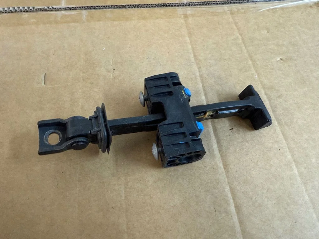 Rear door check strap stopper