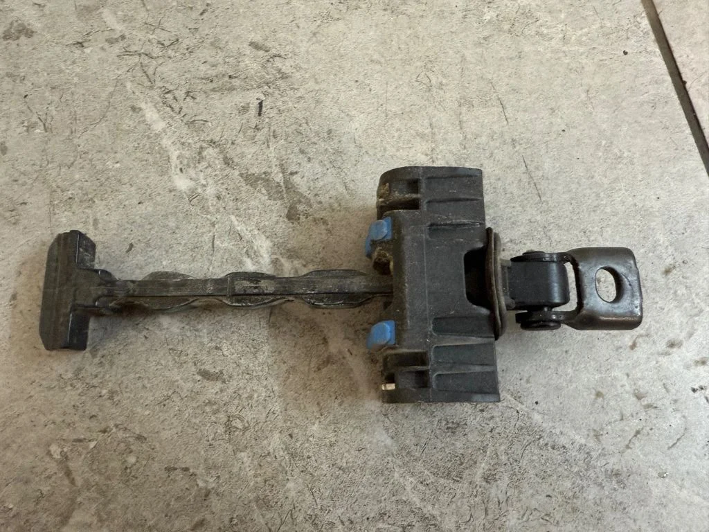 Rear door check strap stopper