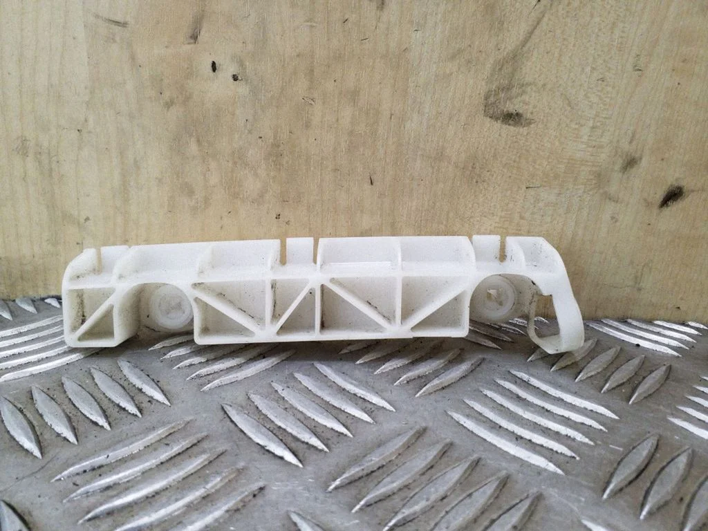 Rear bumper mounting bracket – left