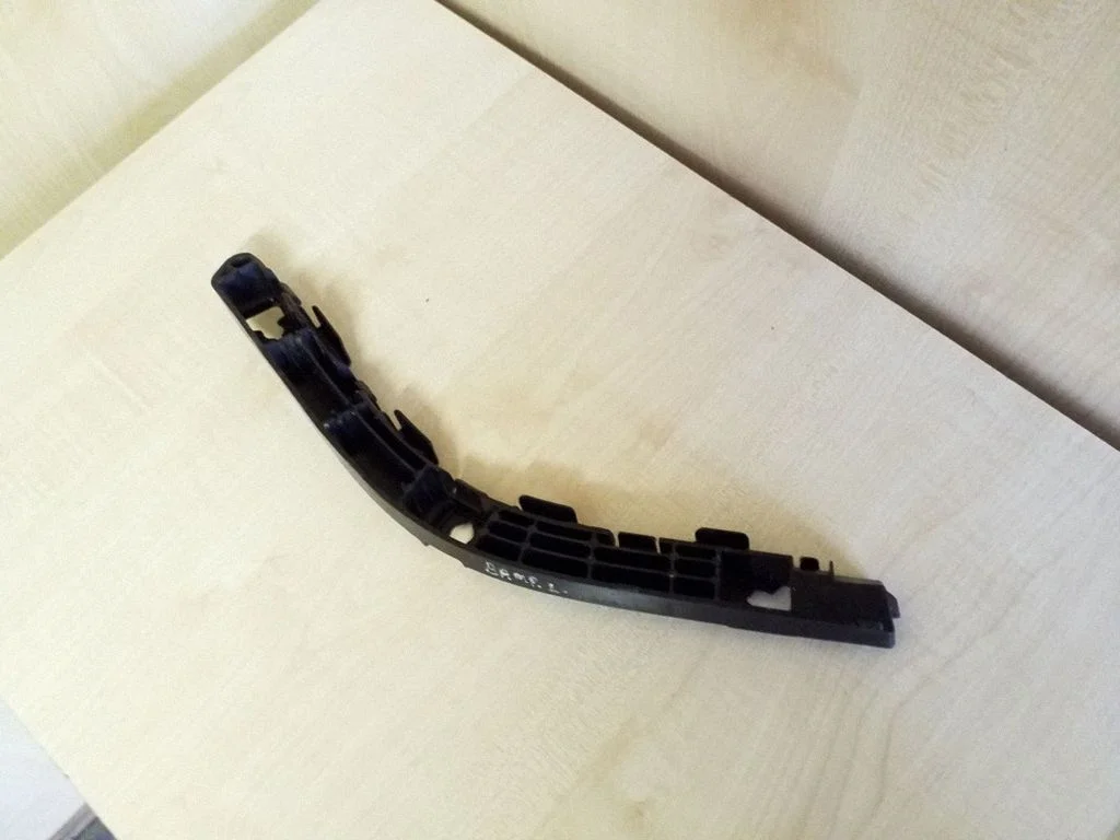 Rear bumper mounting bracket – left