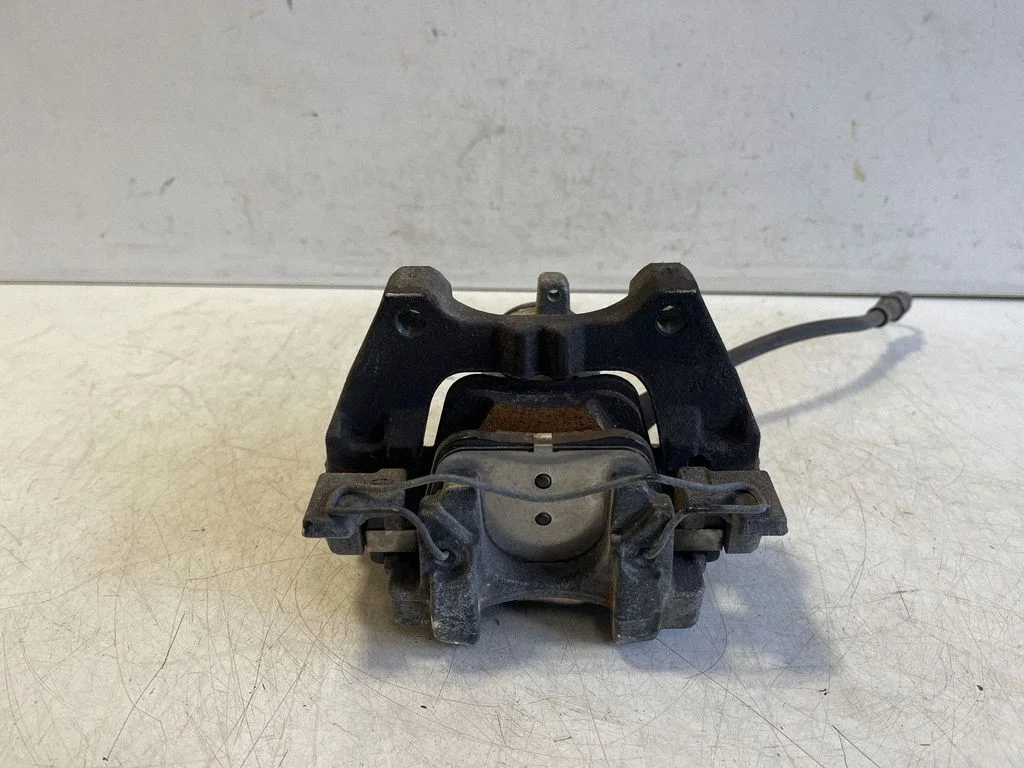 Rear brake caliper – left