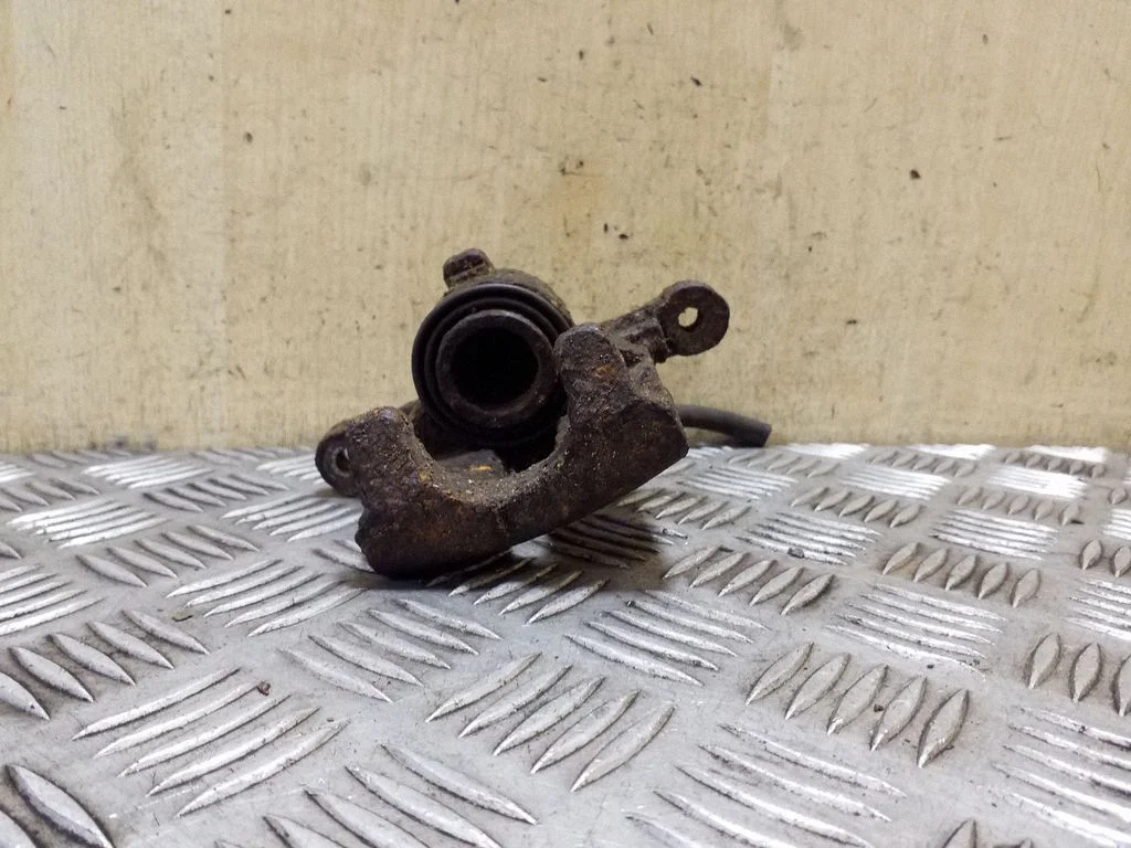 Rear brake caliper – left