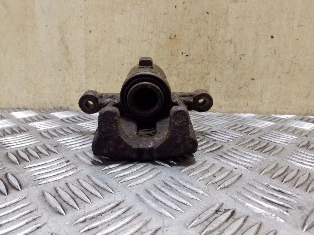 Rear brake caliper – left