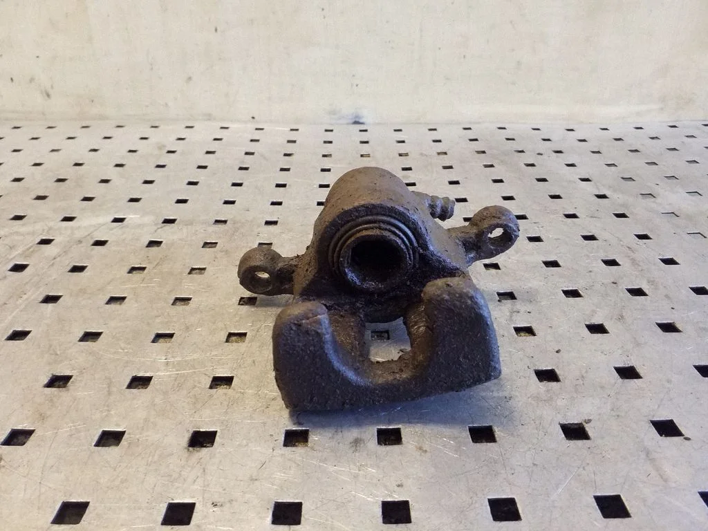 Rear brake caliper – left