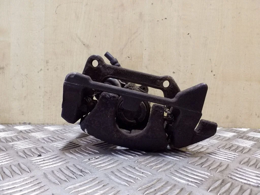 Rear brake caliper – left
