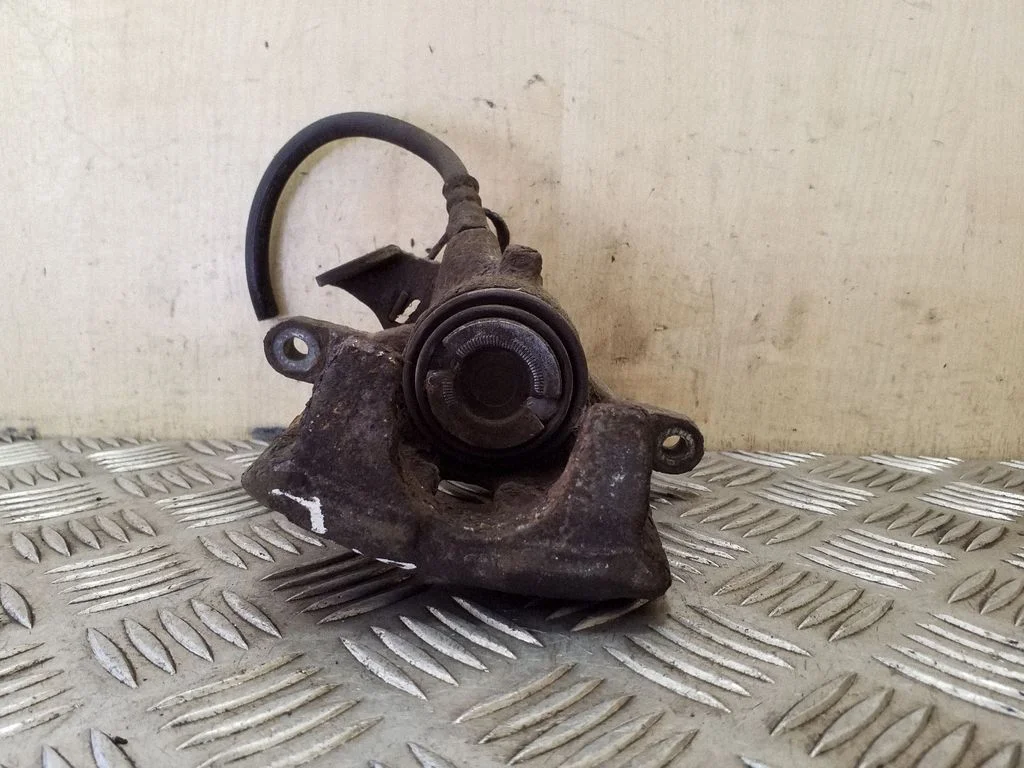Rear brake caliper – left