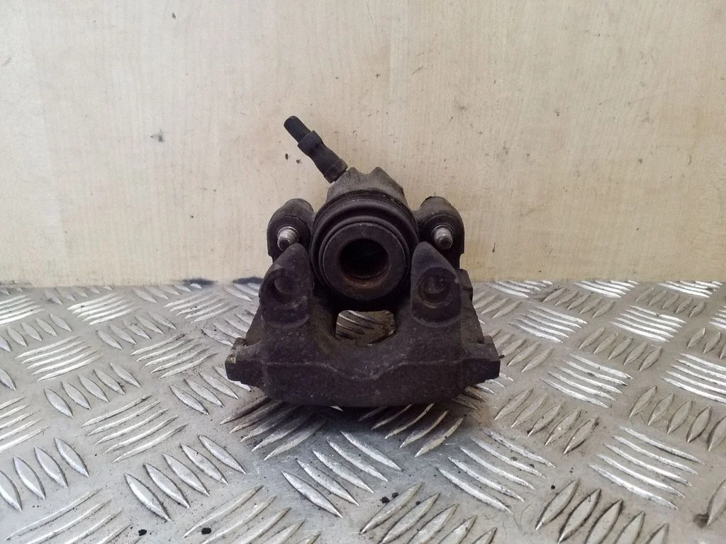 Rear brake caliper – left