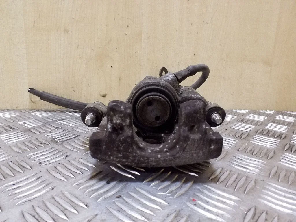 Rear brake caliper – left