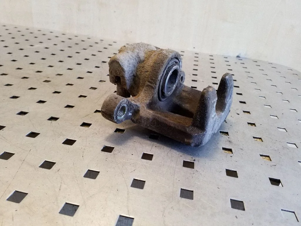 Rear brake caliper – left
