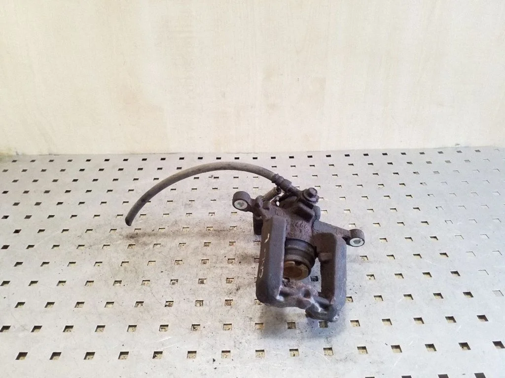 Rear brake caliper – left