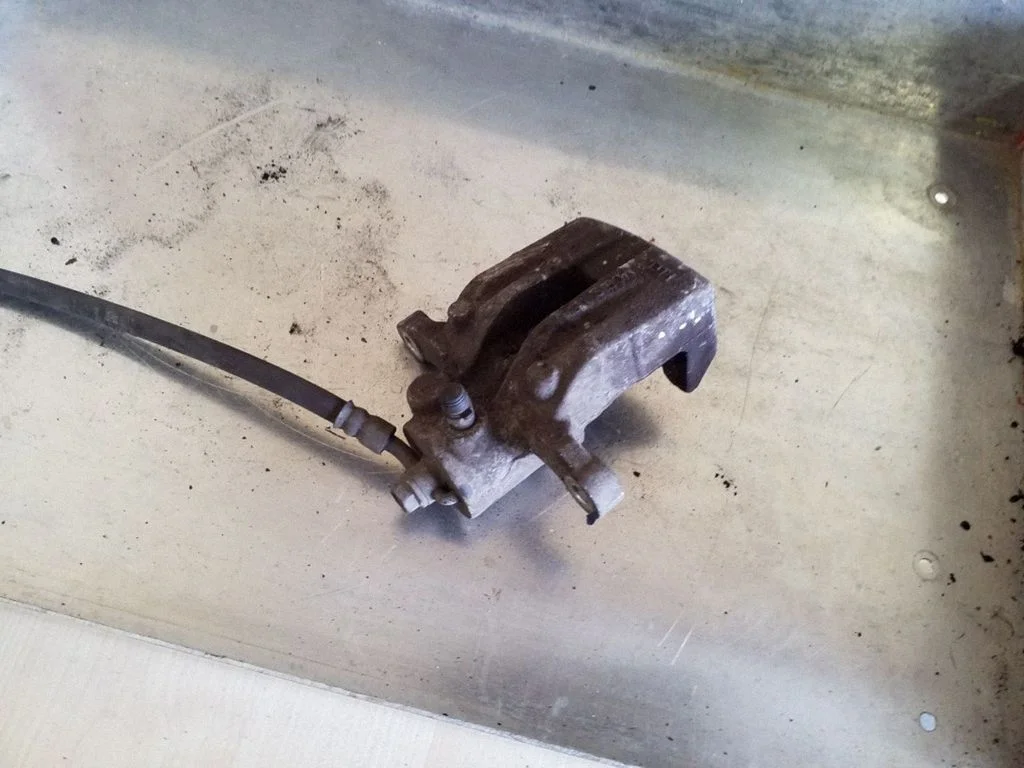 Rear brake caliper – left