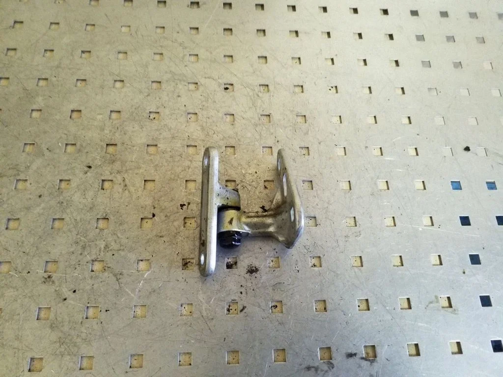 Front door upper hinge – left