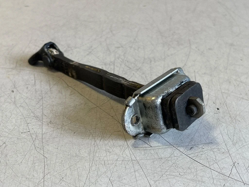 Front door check strap stopper – left