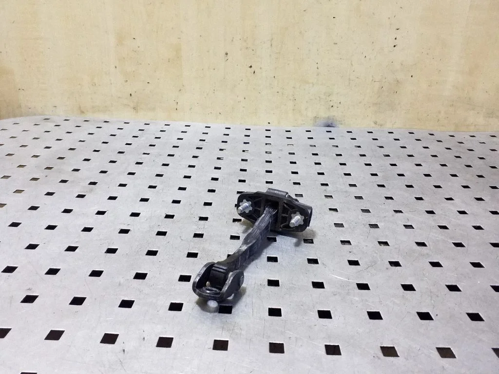 Front door check strap stopper 31299810