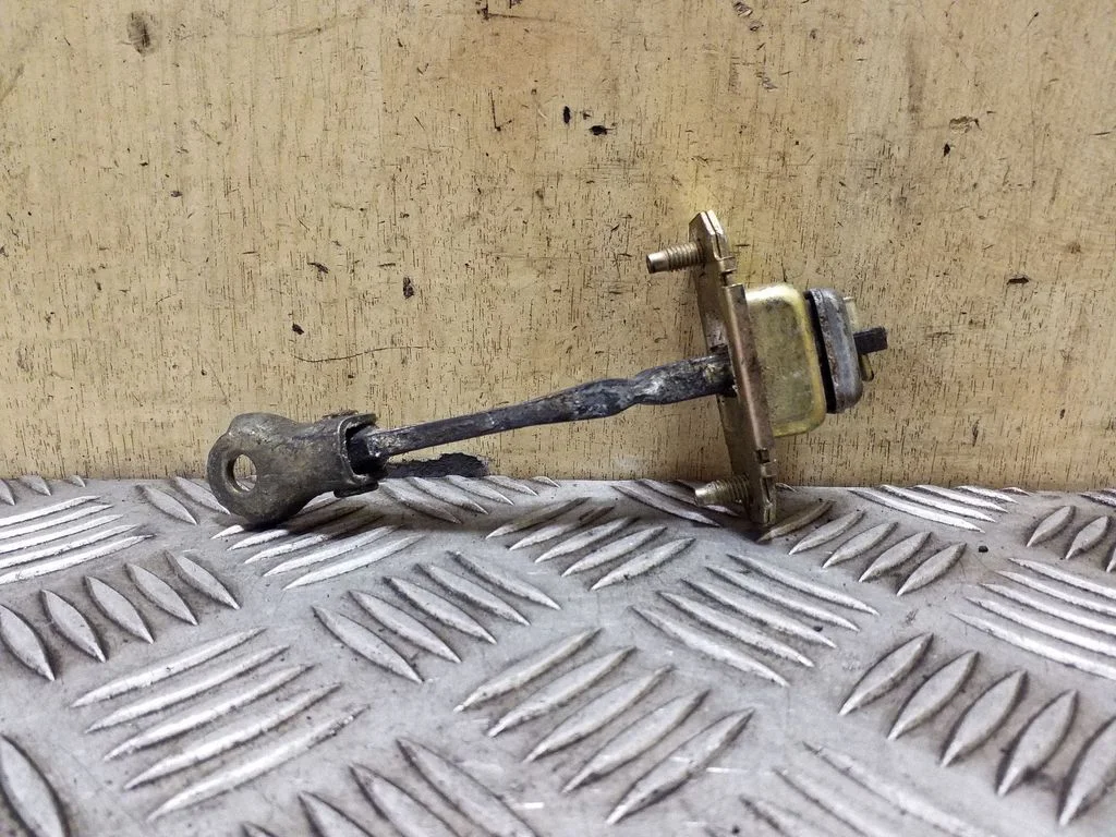Front door check strap stopper – left