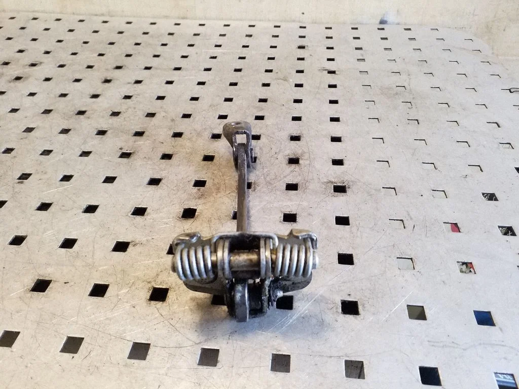Front door check strap stopper 311823G