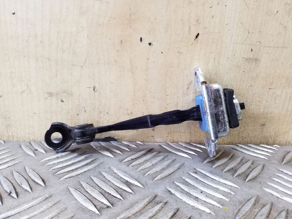 Front door check strap stopper – left