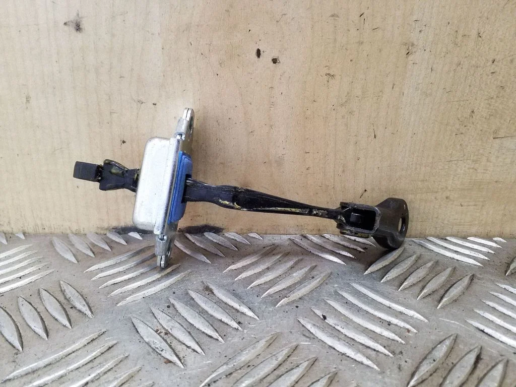 Front door check strap stopper – left