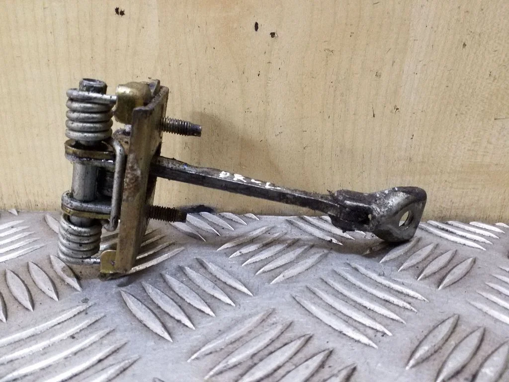 Front door check strap stopper – left