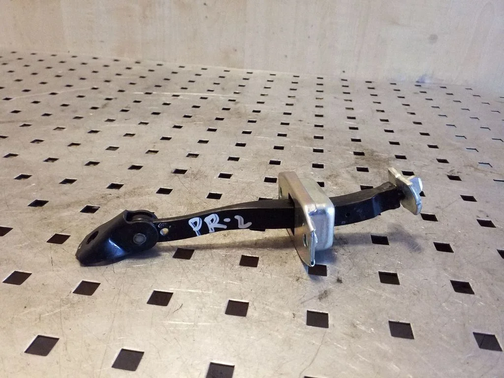 Front door check strap stopper – left