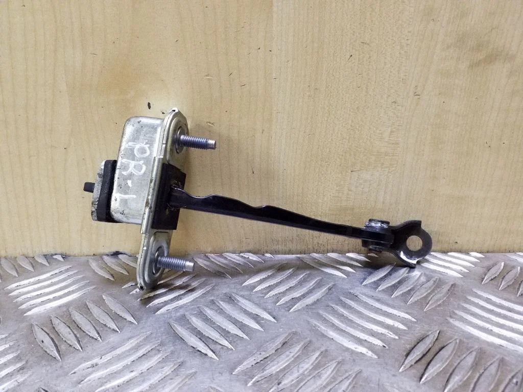 Front door check strap stopper – left