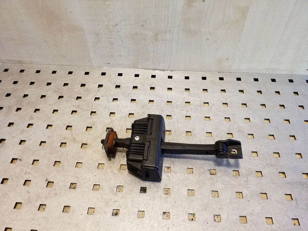 Front door check strap stopper 7033609