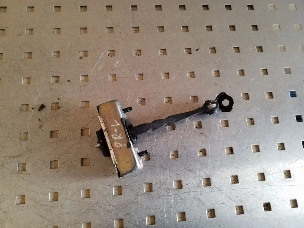 Front door check strap stopper – left