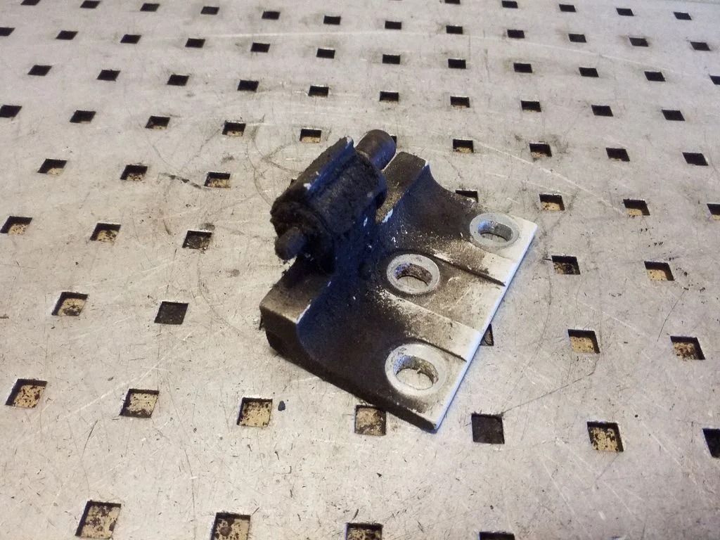 Front door lower hinge – left