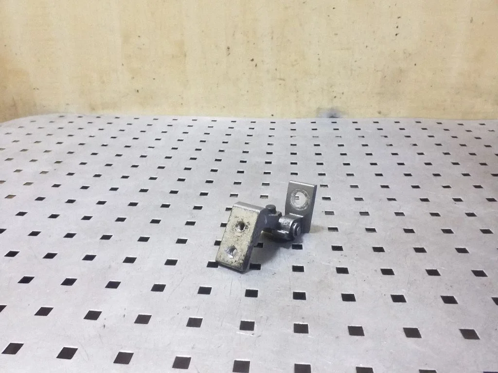 Rear door upper hinge – left