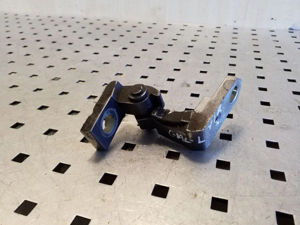 Rear door upper hinge – left