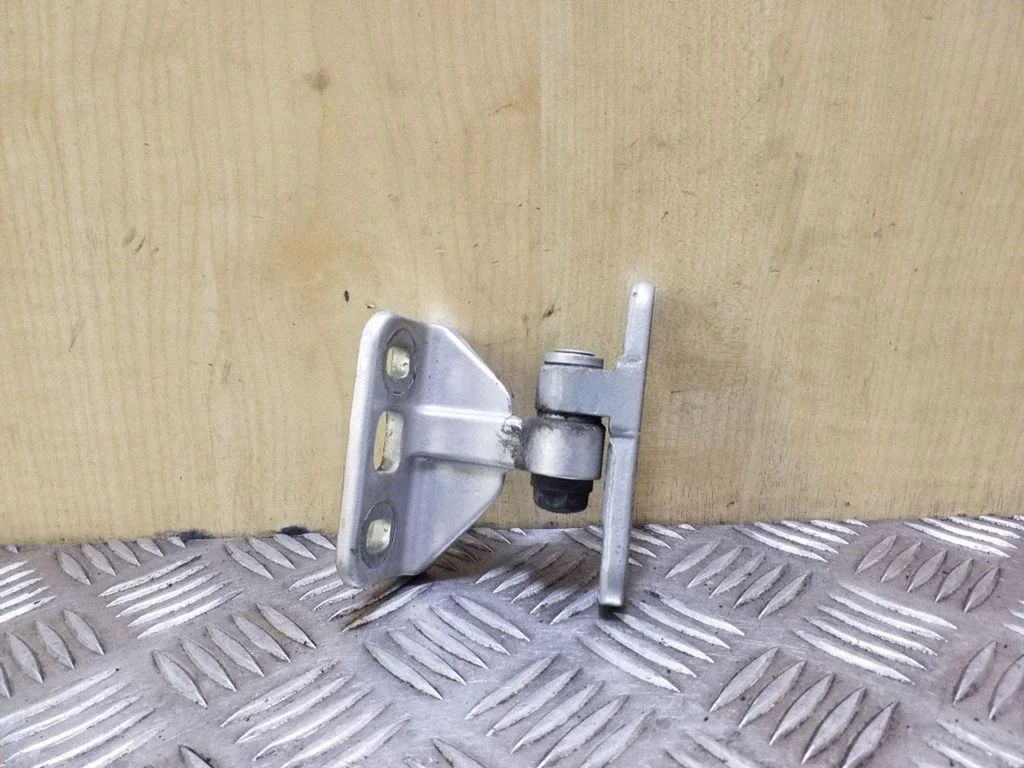 Rear door upper hinge – left