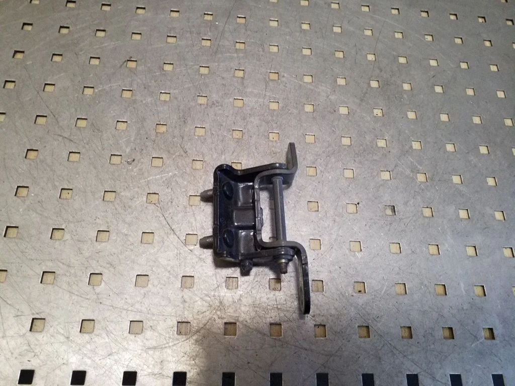 Rear door upper hinge – left