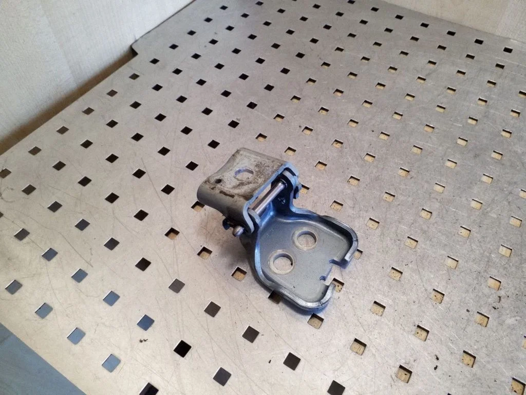 Rear door upper hinge – left