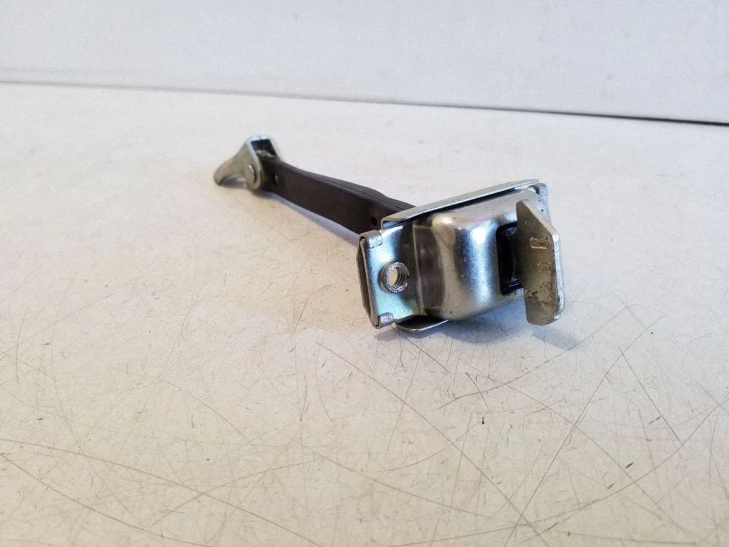 Rear door check strap stopper – left