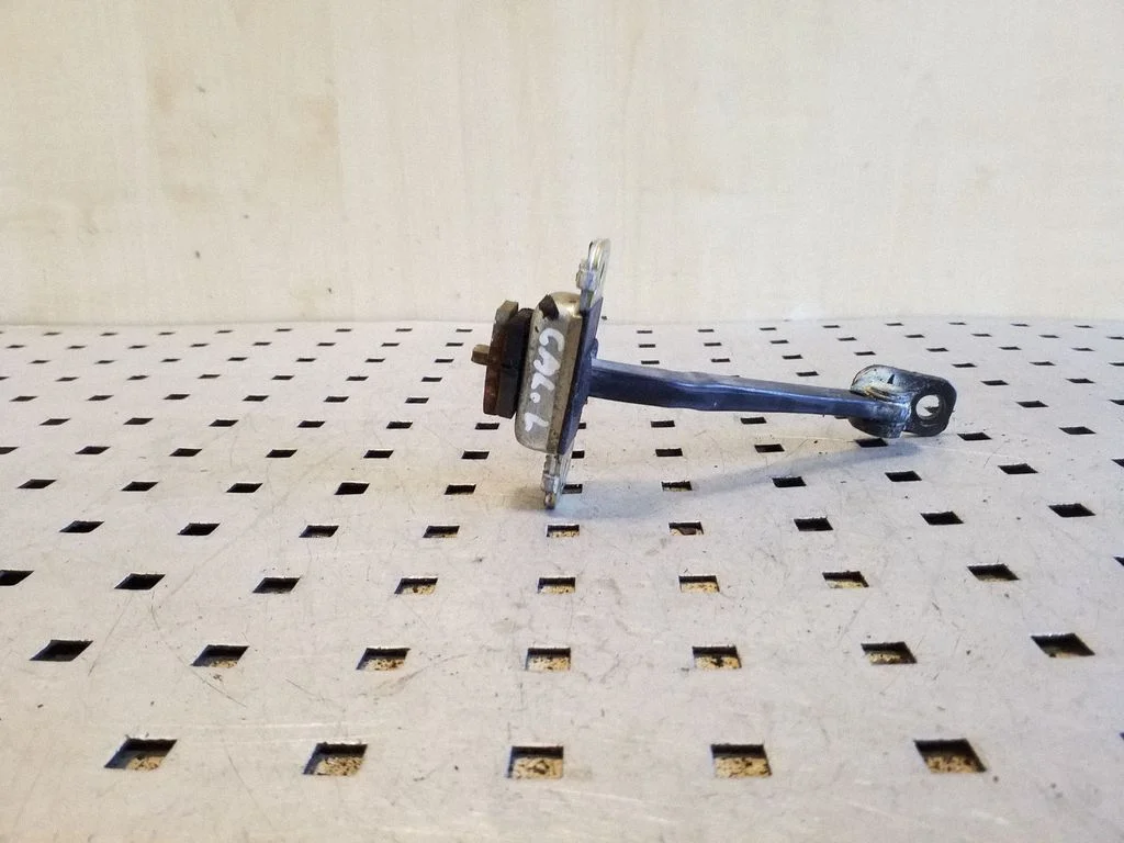 Rear door check strap stopper – rear left