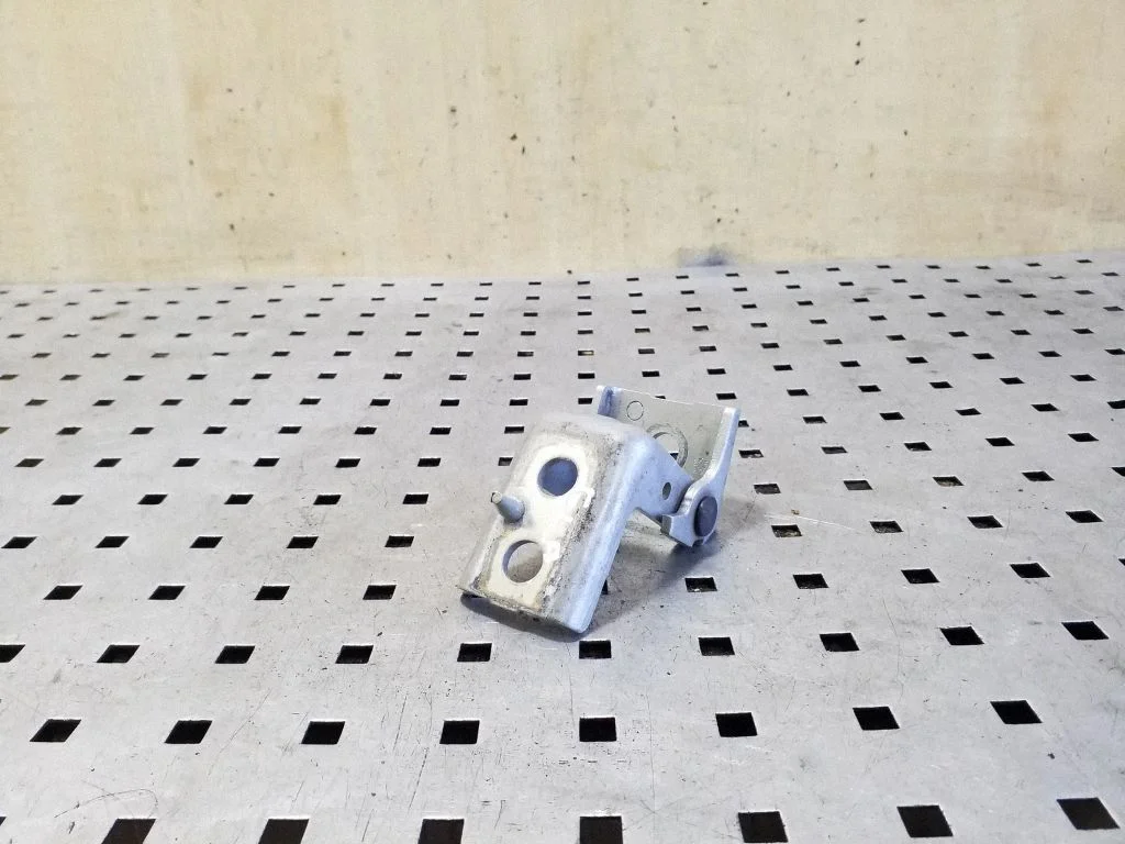 Rear door lower hinge – left