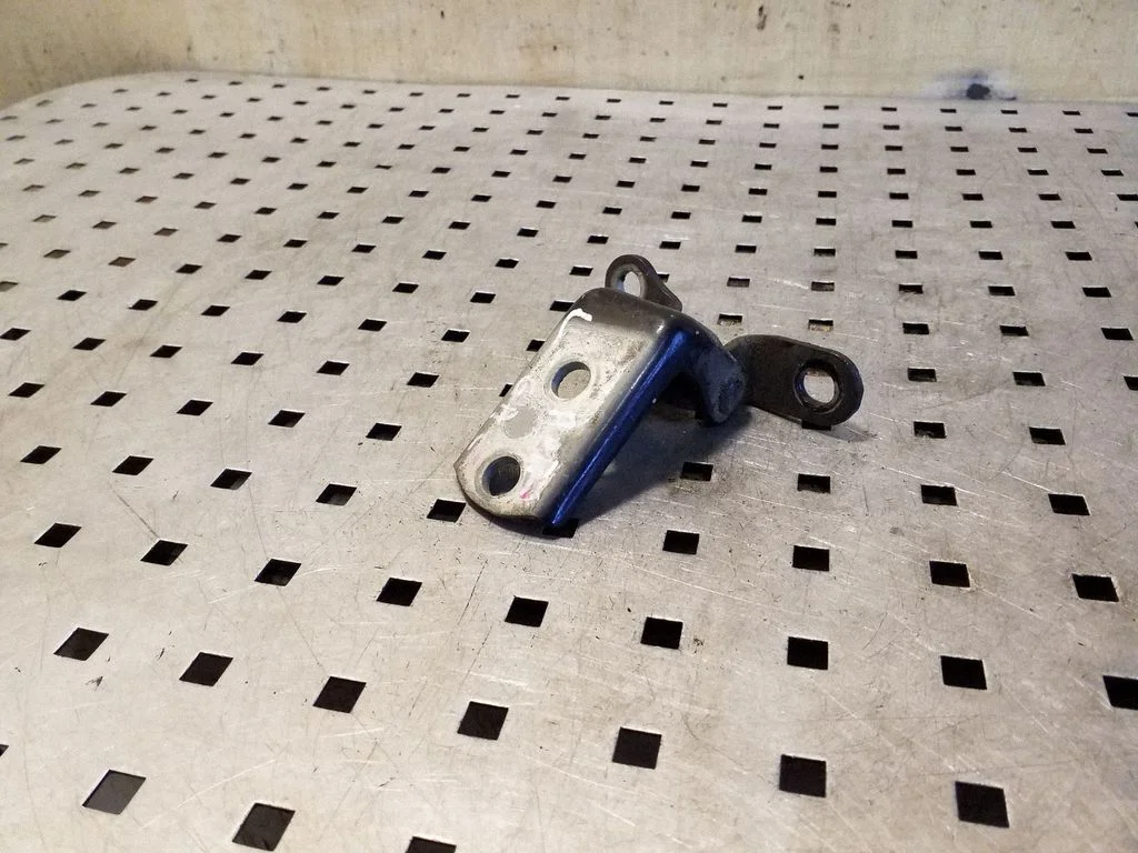Rear door lower hinge – left