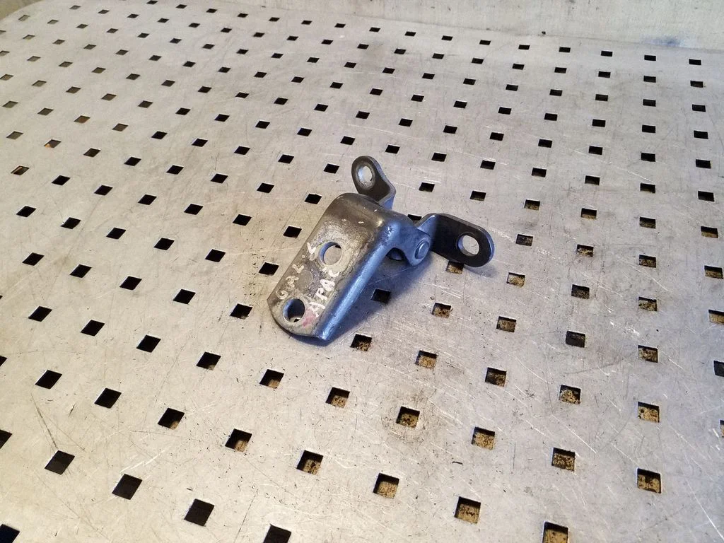 Rear door lower hinge – left