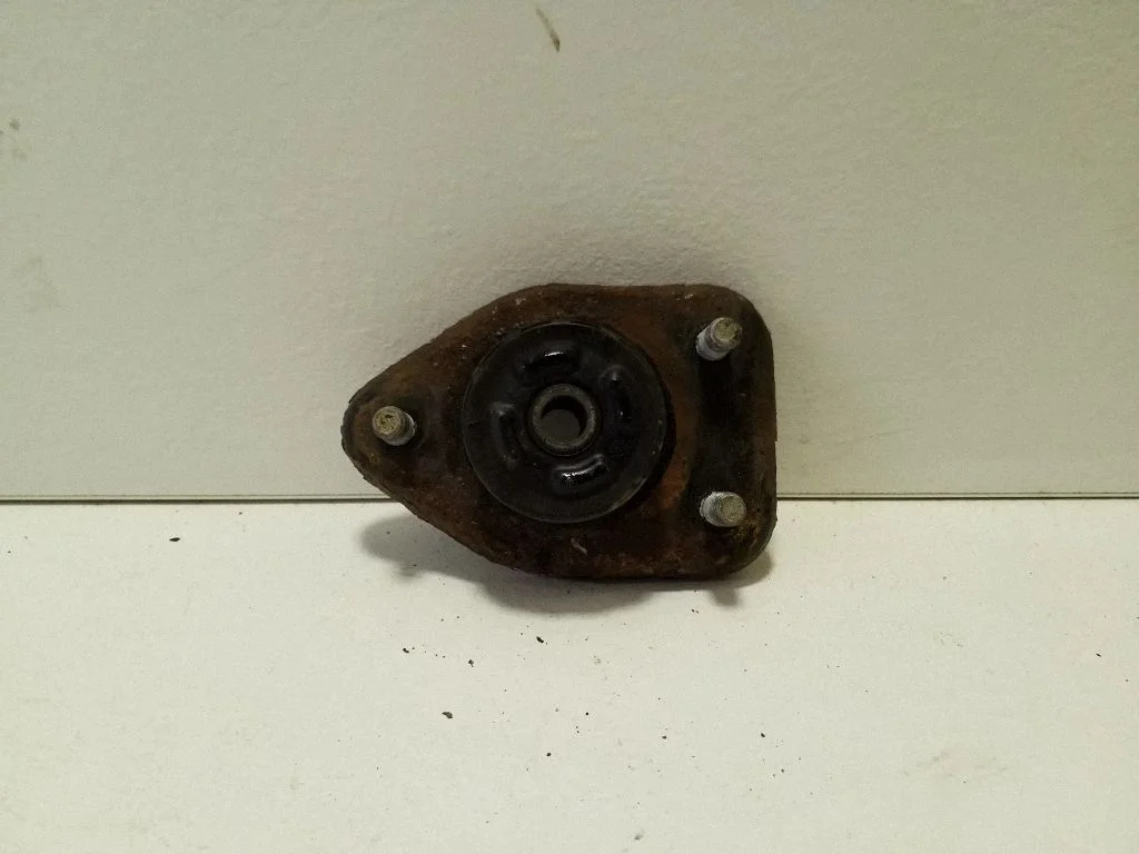 Front shock absorber mounting bracket – left