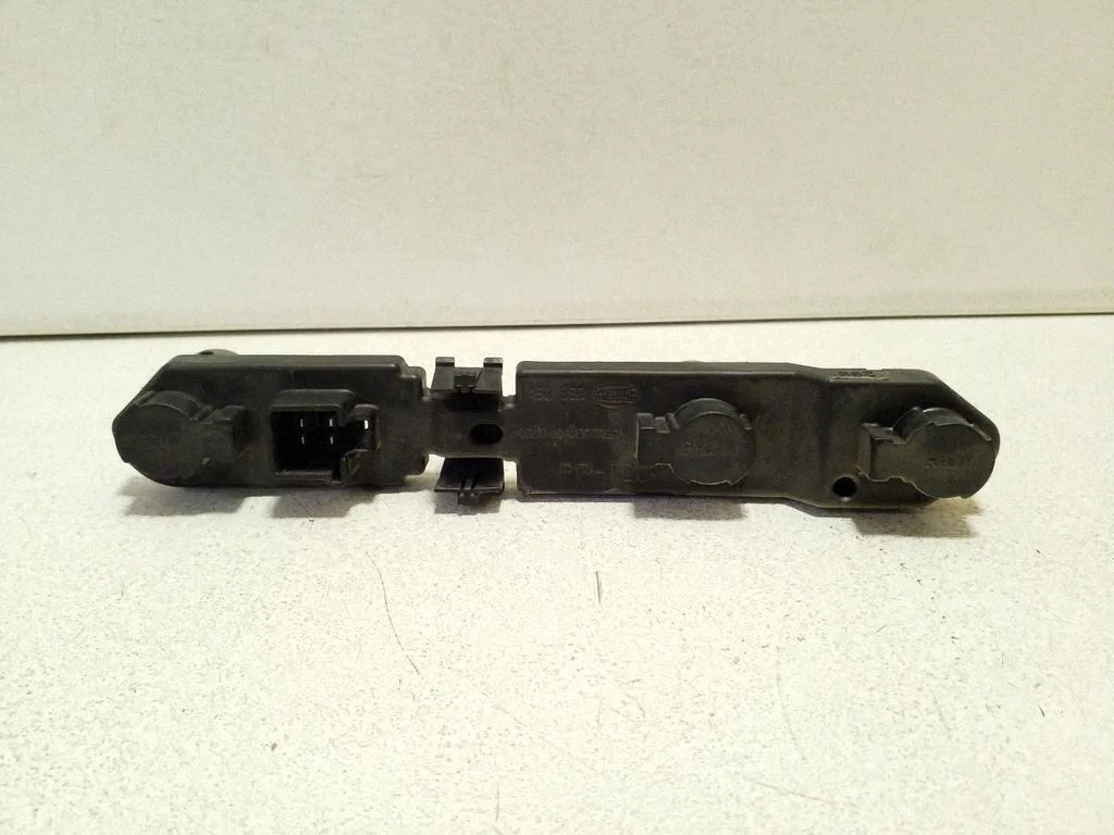 Tail light bulb cover holder – right