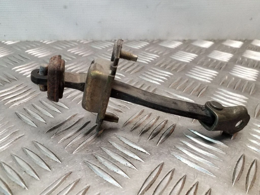 Front door check strap stopper