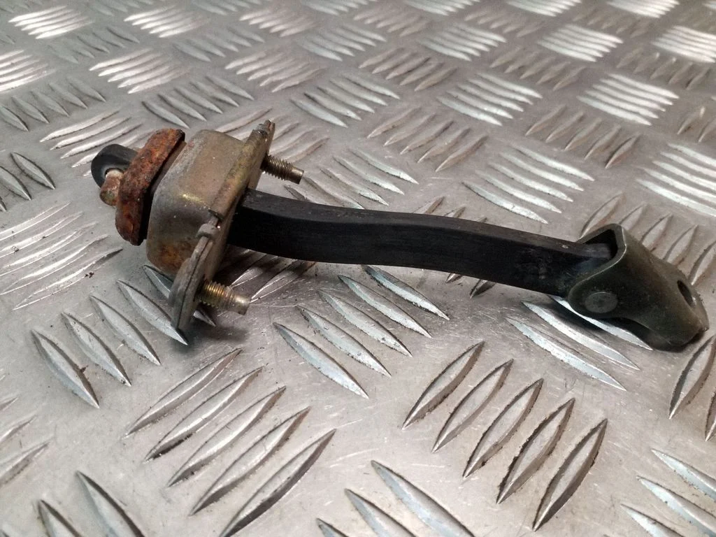 Front door check strap stopper
