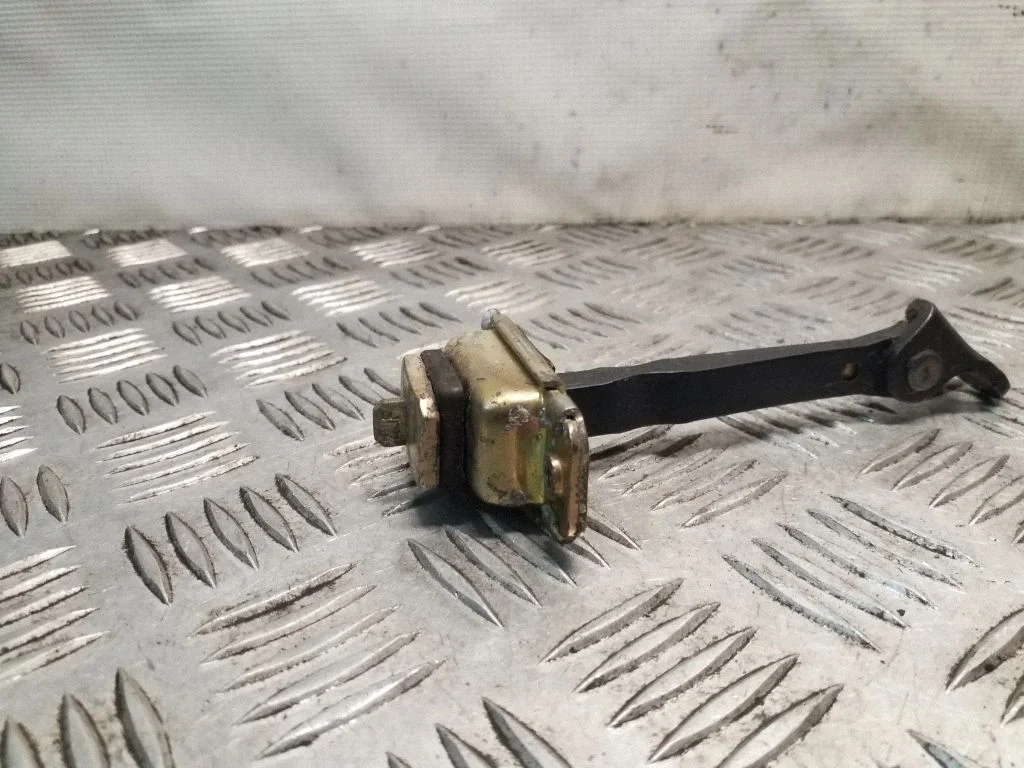 Rear door check strap stopper – left
