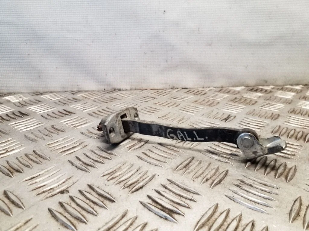 Rear door check strap stopper – rear left