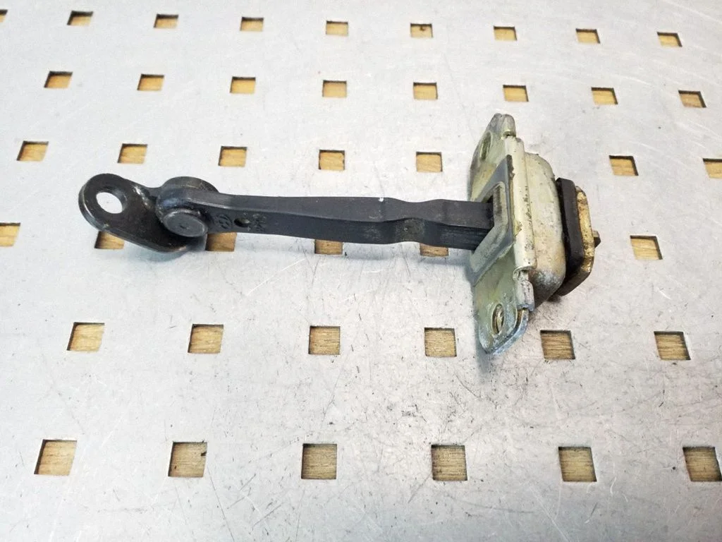 Rear door check strap stopper – rear left