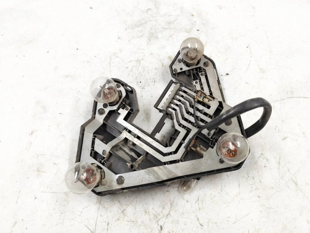 Tail light bulb cover holder – rear left