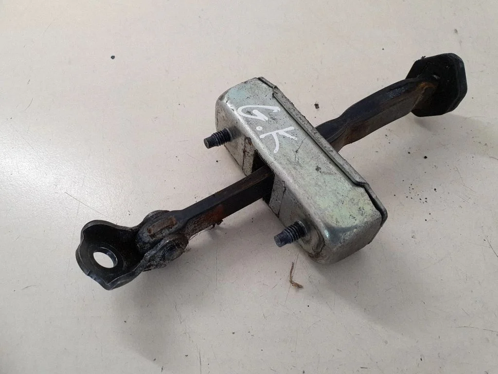 Rear door check strap stopper – left