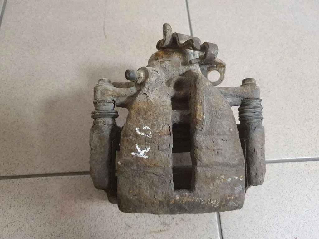 Rear brake caliper – left