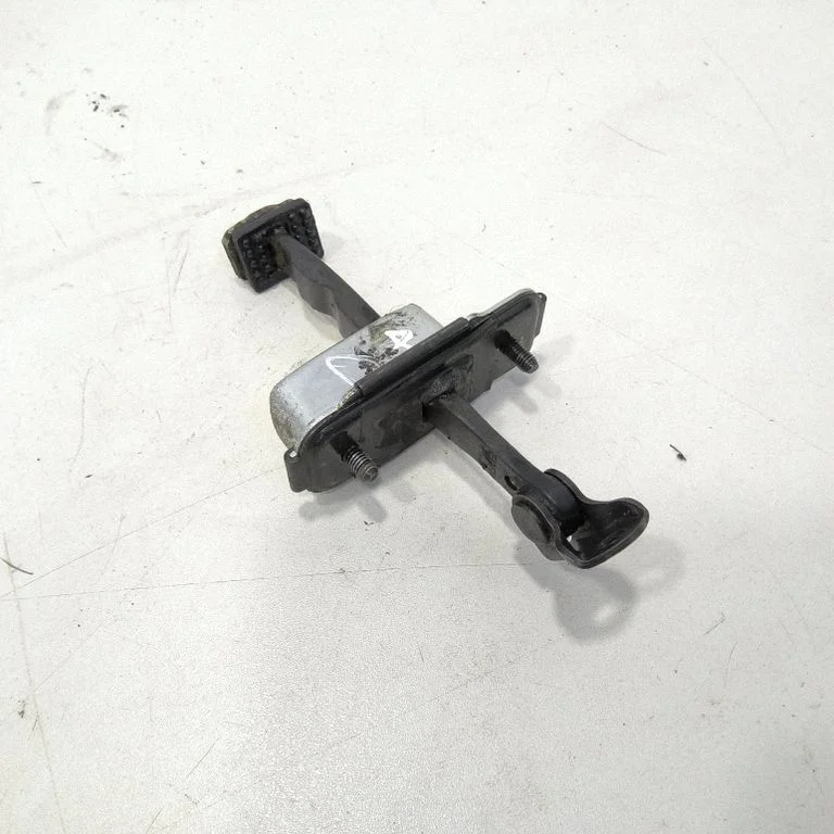 Front door check strap stopper – front right
