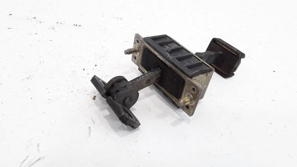 Rear door check strap stopper – rear left